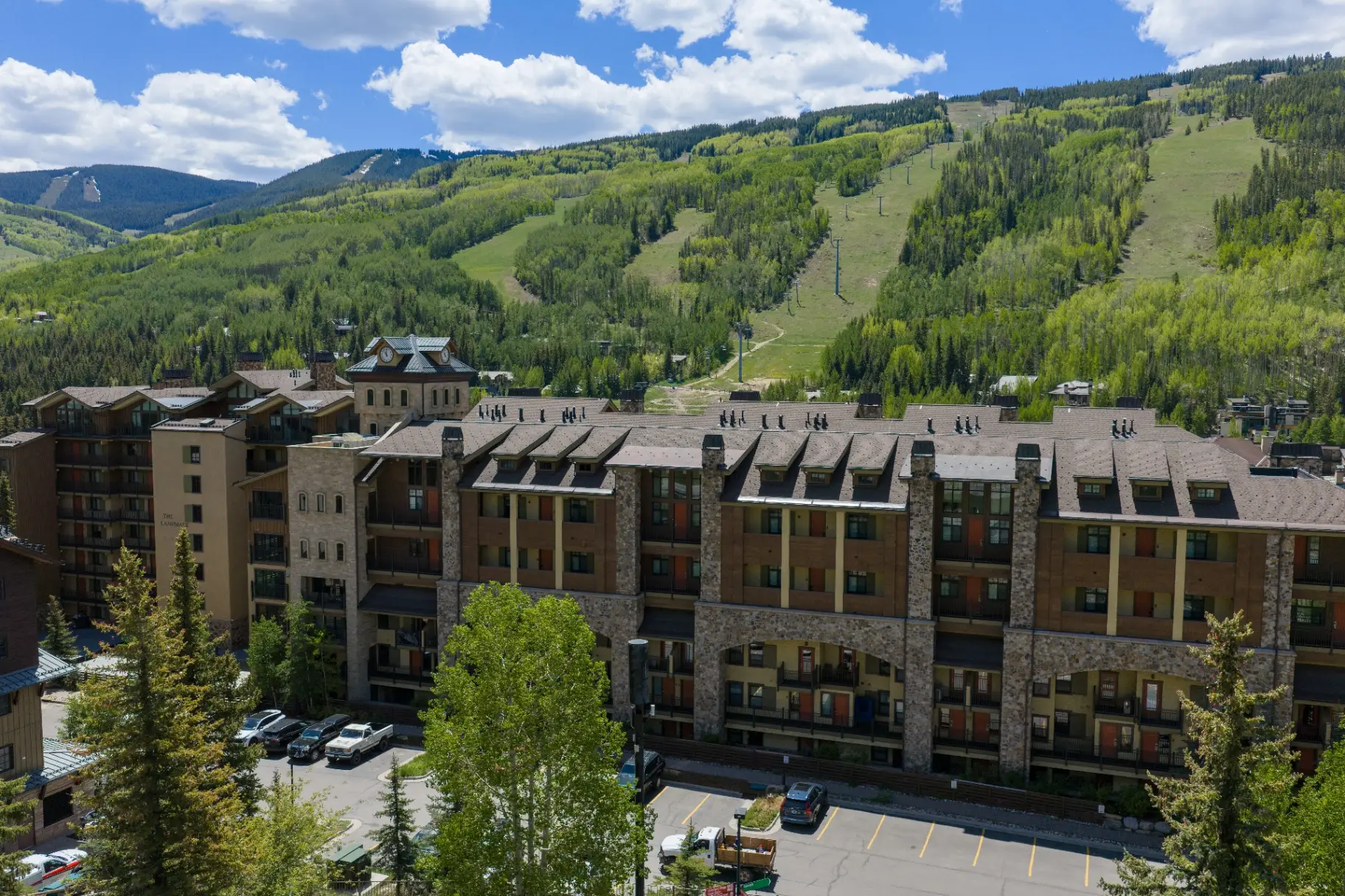 Front elevation of The Landmark with ski slopes behind