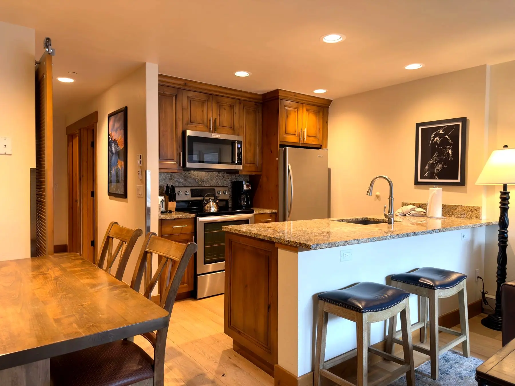 Kitchen with granite counters, bar seating, and dining table
