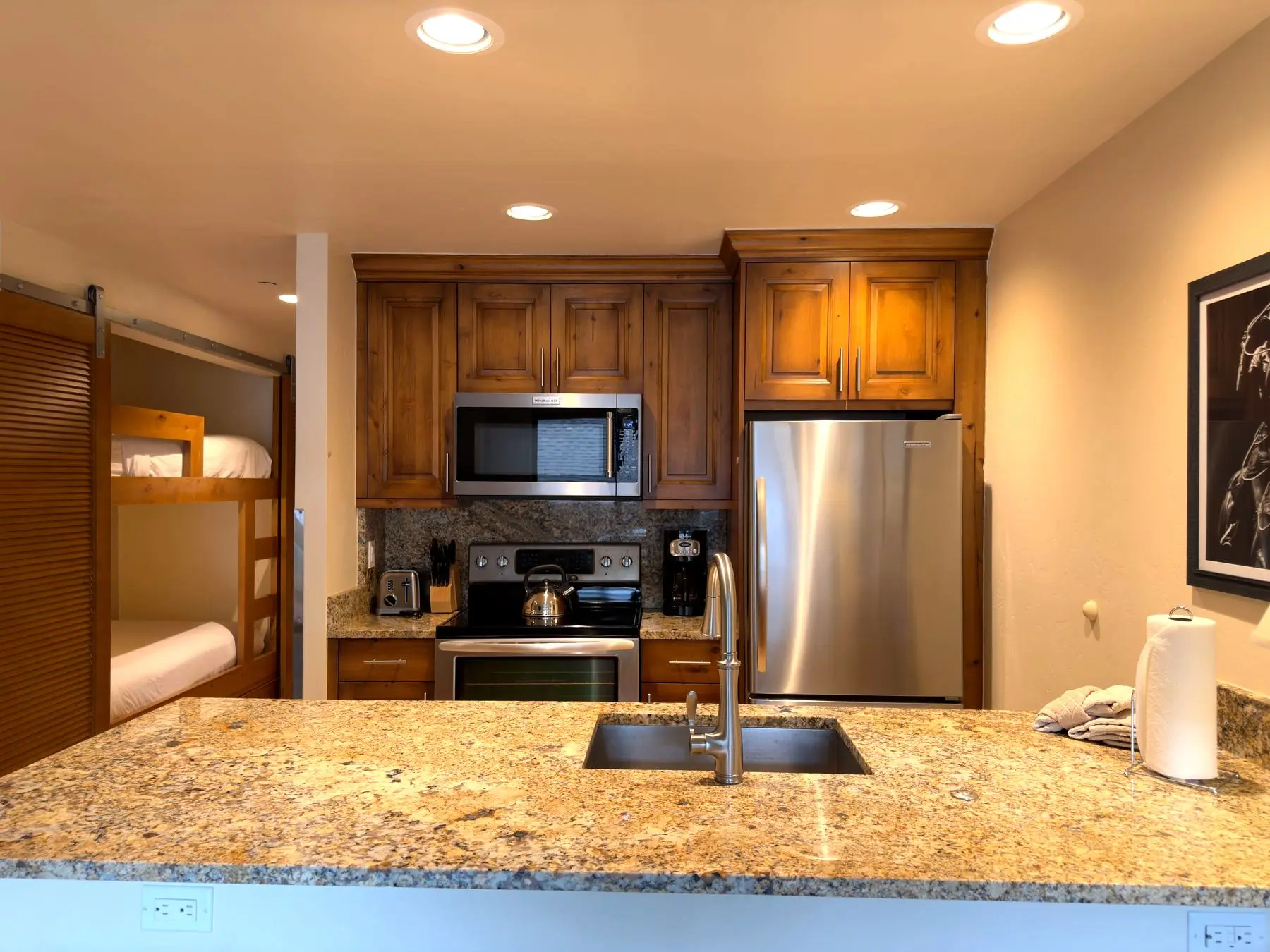 Kitchen view with built-in bunk nook beyond
