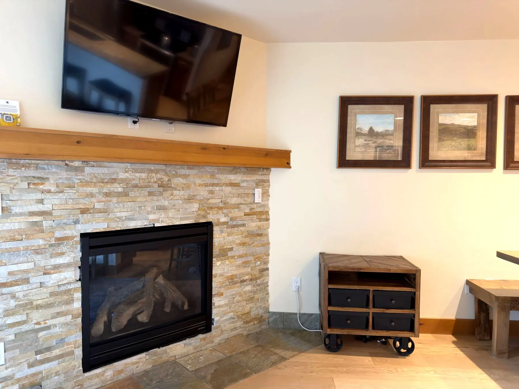 Stone-stacked gas fireplace with mounted TV