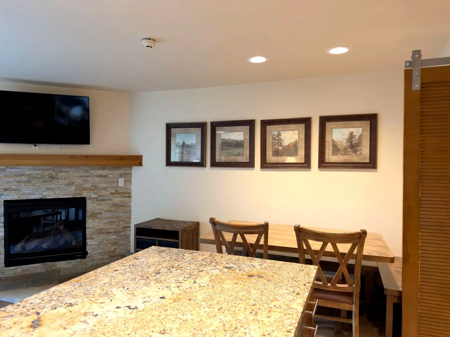 Dining nook with framed landscape art
