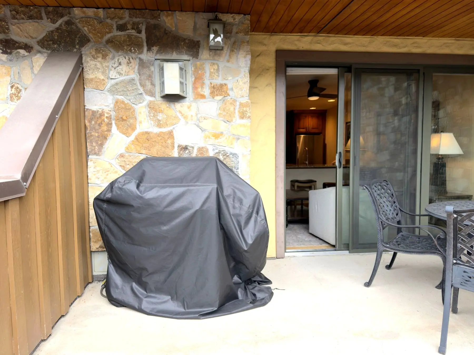 Covered terrace with grill and sliding doors to interior