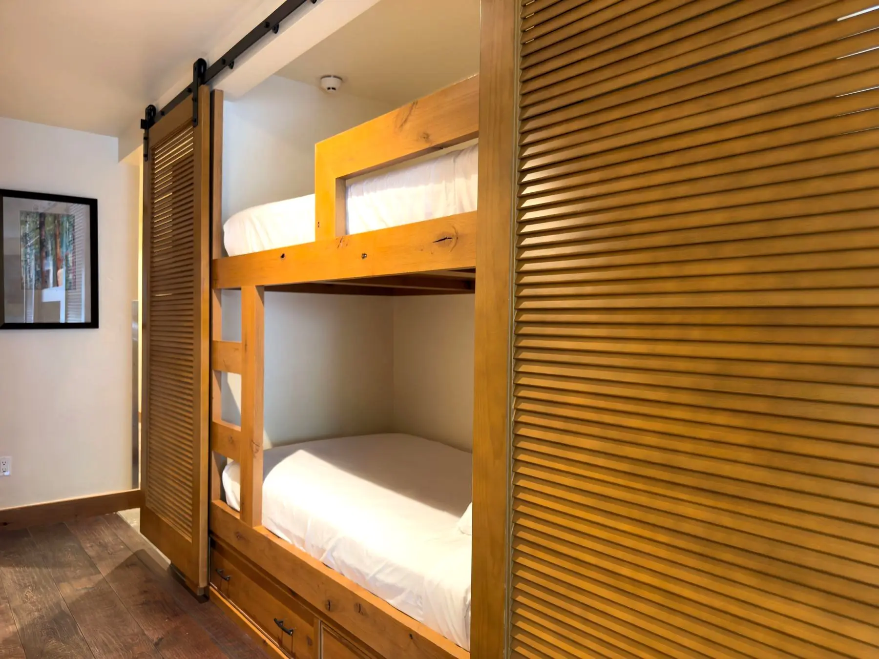 Built-in bunk nook with barn-door privacy