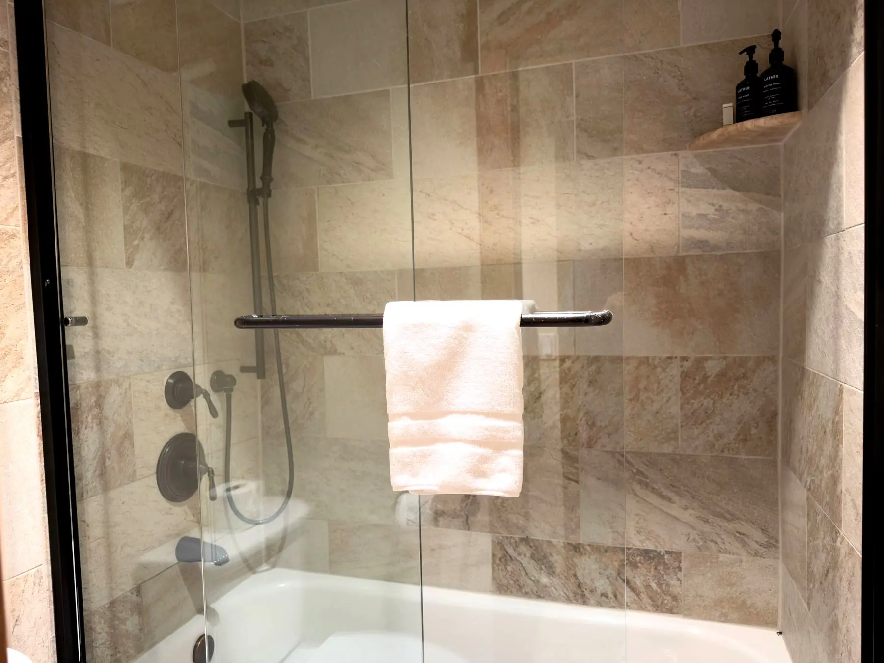Walk-in tub/shower with handheld fixture